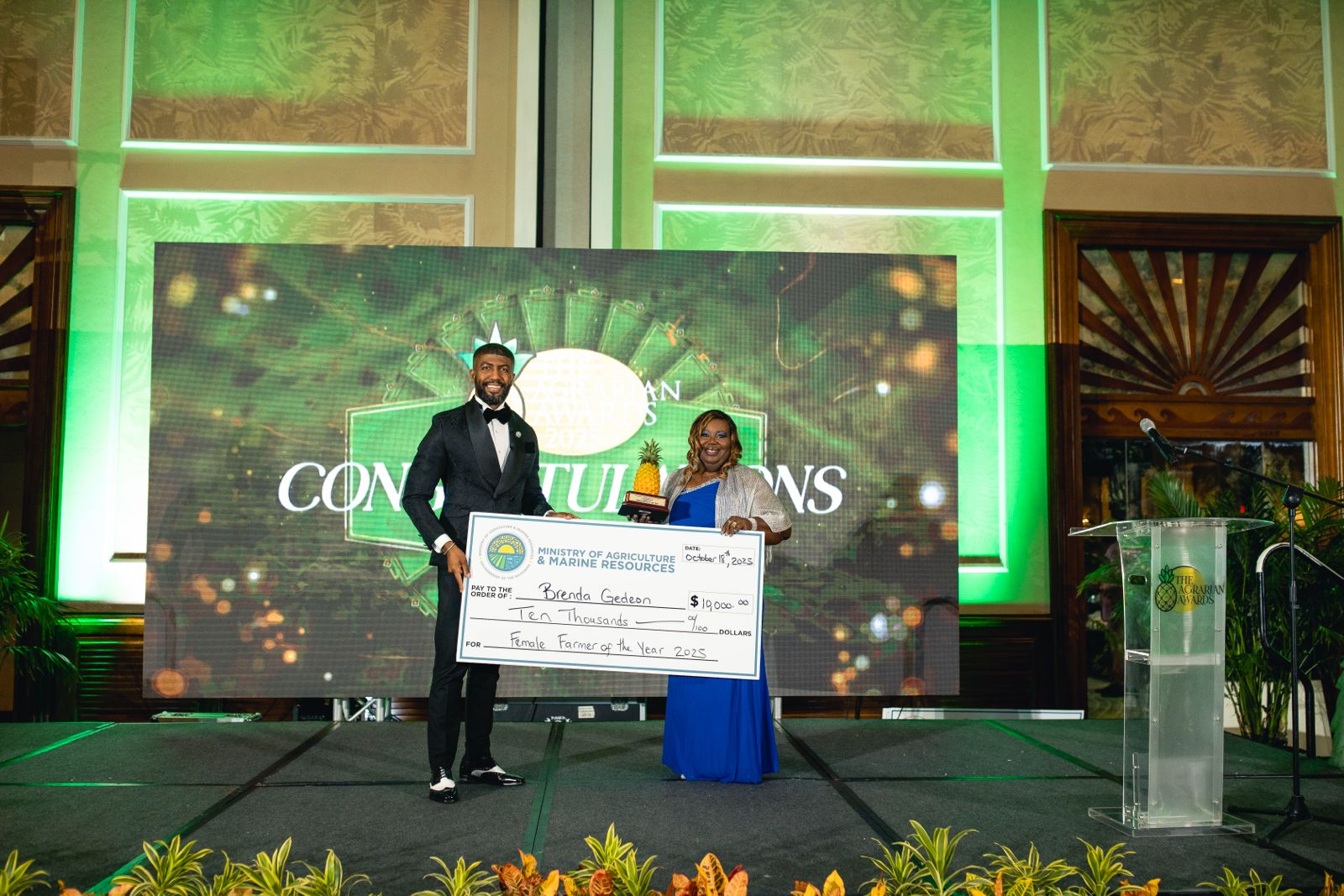 BPL Director of Communication Theodore Sealy presents the 2025 Agrarian Awards Female Farmer of the Year Award to Brenda Gedeon
